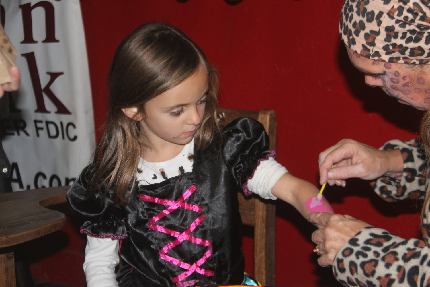 Dakota Blum gets a temporary tattoo at the Wellman Halloween Party at the Wellman Skating Rink on Oct. 31.